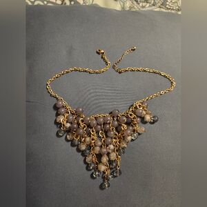Gold tone style necklace with multicolored beads.